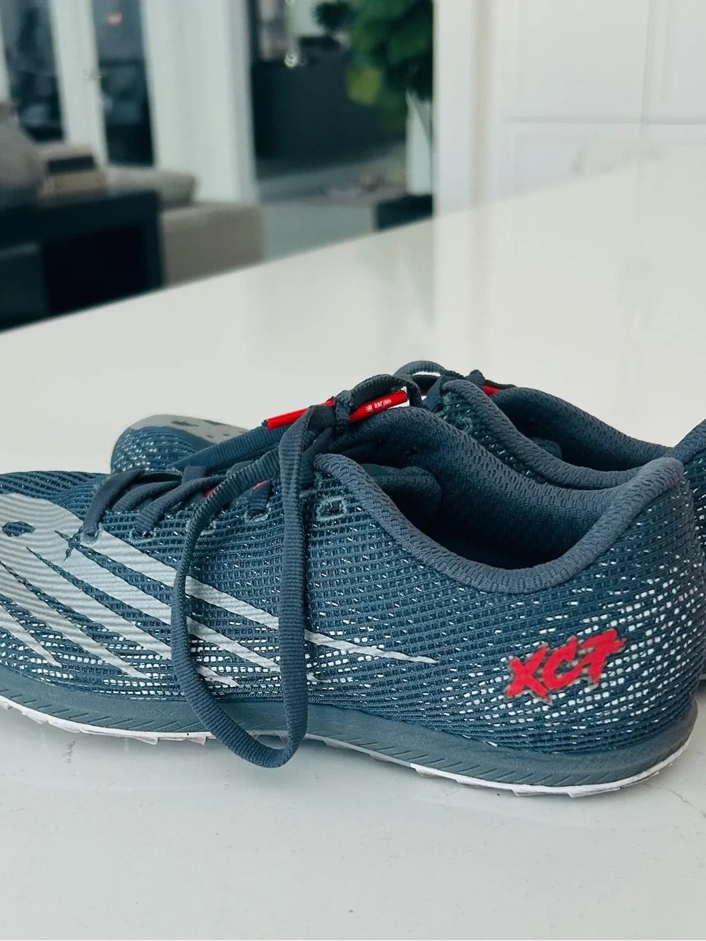 New Balance Men's Racing Shoes in Charcoal Gray with White and Red Accents
